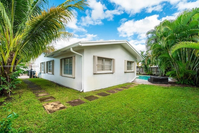 view of side of home featuring a lawn