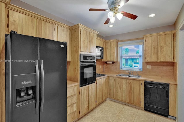 kitchen featuring black appliances, light brown cabinets, and sink