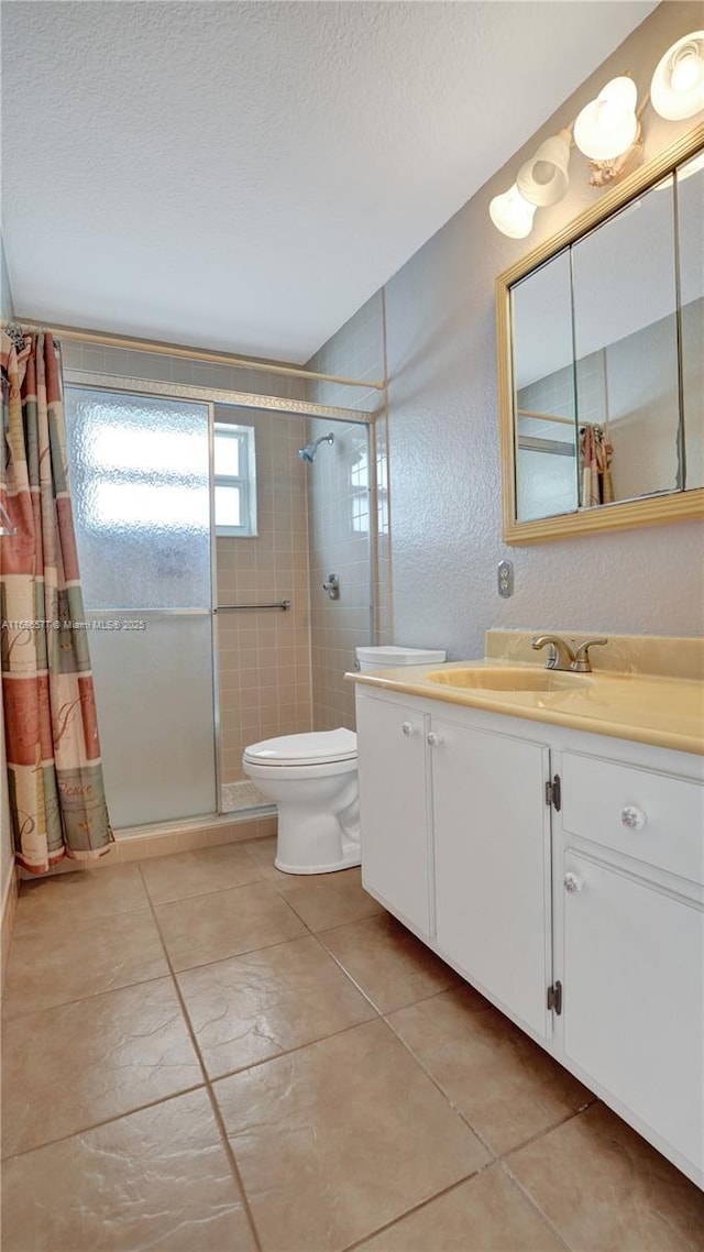 bathroom featuring a shower with shower curtain, tile patterned floors, vanity, and toilet