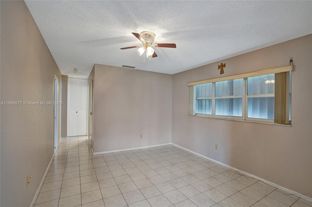 empty room featuring ceiling fan and a textured ceiling