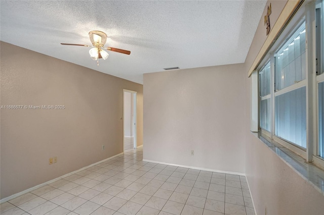 spare room with ceiling fan and a textured ceiling