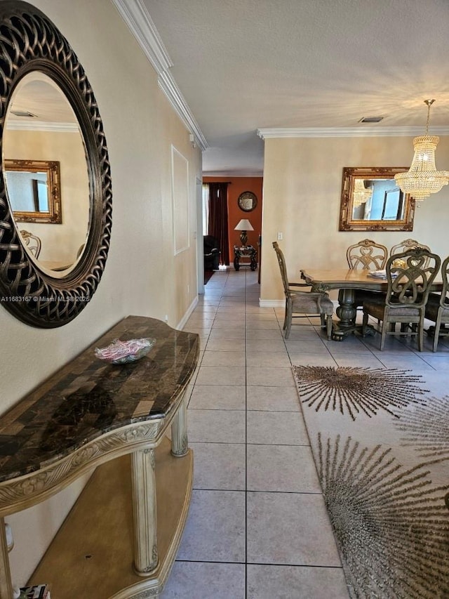 hall featuring light tile patterned floors, crown molding, a notable chandelier, and a textured ceiling