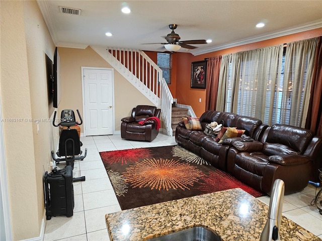 living room featuring ceiling fan, light tile patterned floors, and crown molding