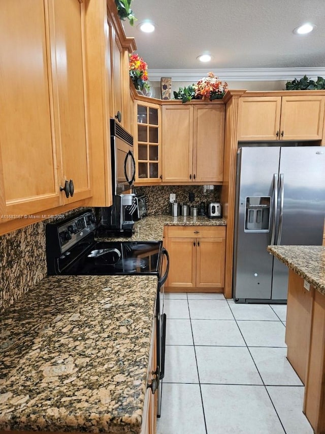 kitchen featuring appliances with stainless steel finishes, an island with sink, sink, a kitchen breakfast bar, and dark stone counters