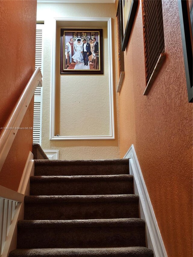 carpeted bedroom with crown molding