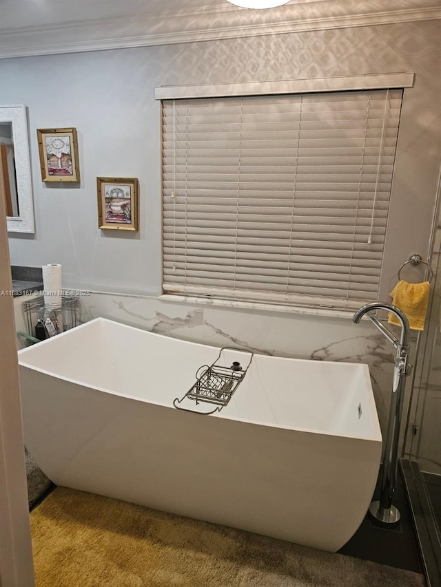 bathroom with a bathtub and ornamental molding