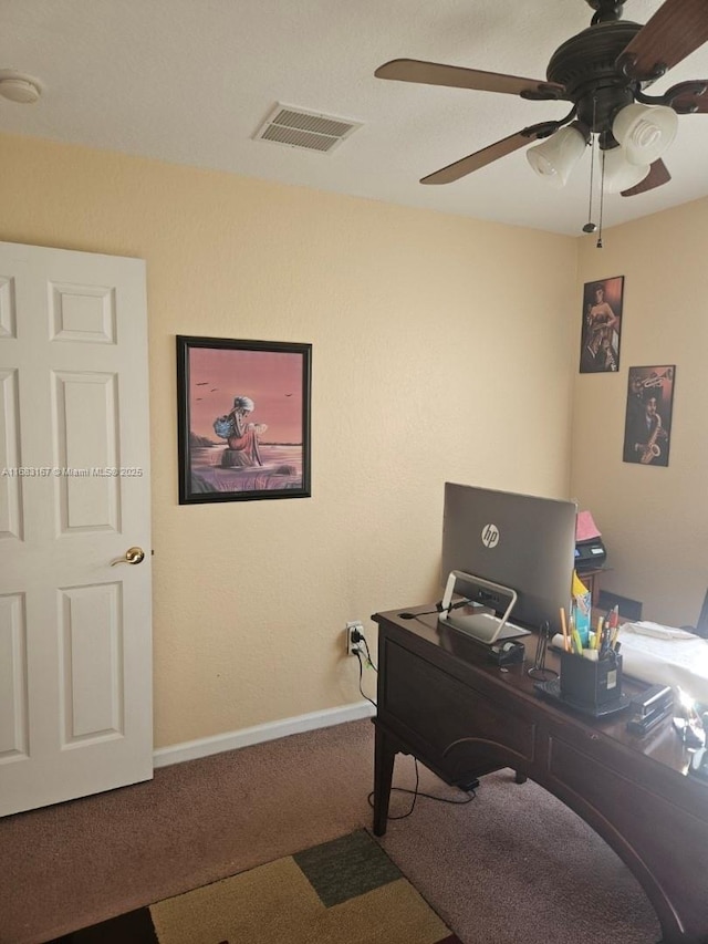 carpeted home office featuring ceiling fan