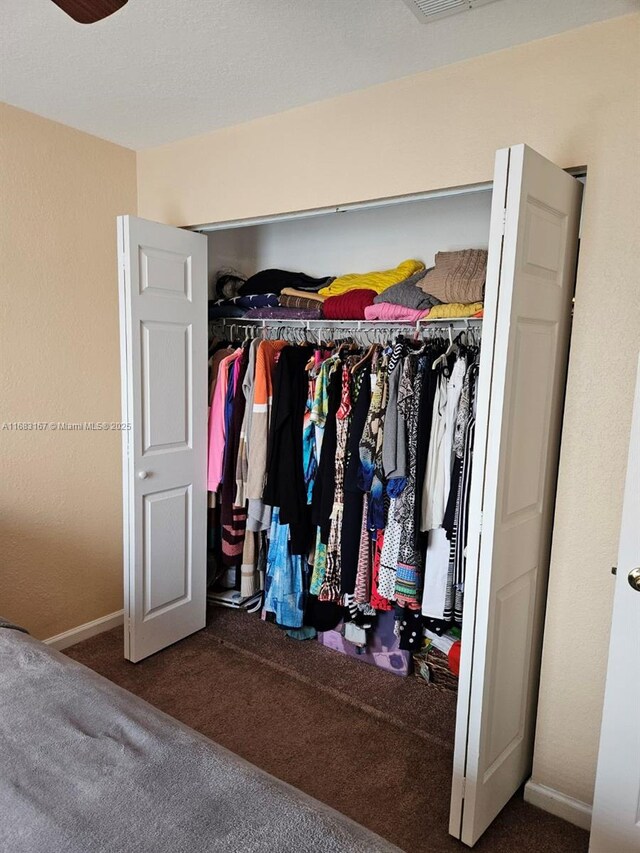 bedroom with ceiling fan and dark carpet