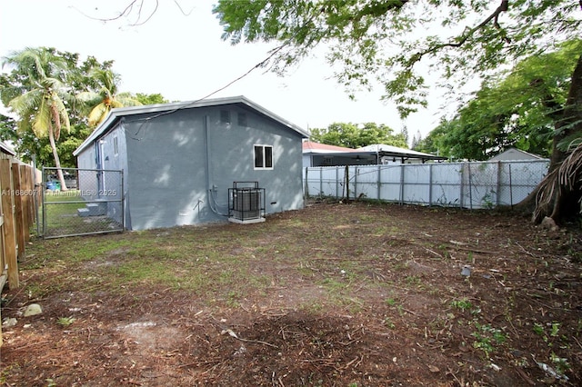 back of house with central AC unit