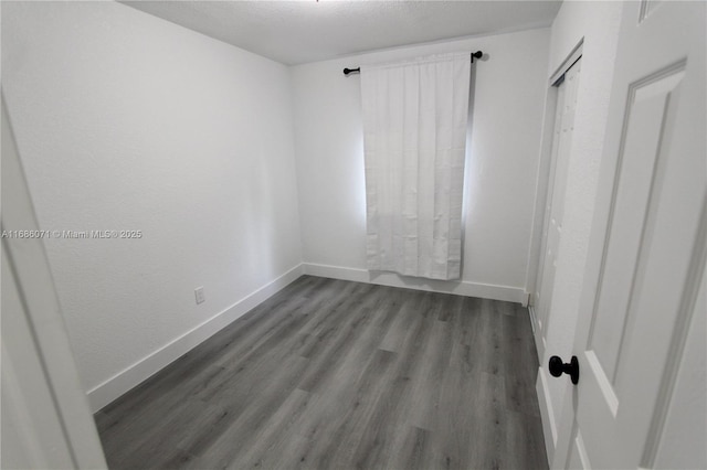 spare room featuring a textured ceiling and wood-type flooring