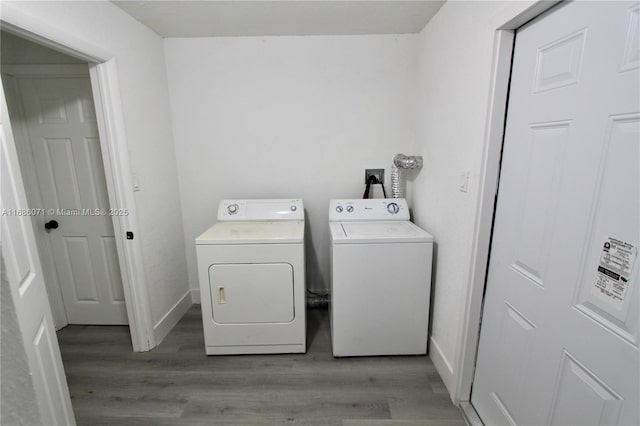 washroom featuring separate washer and dryer and light hardwood / wood-style flooring