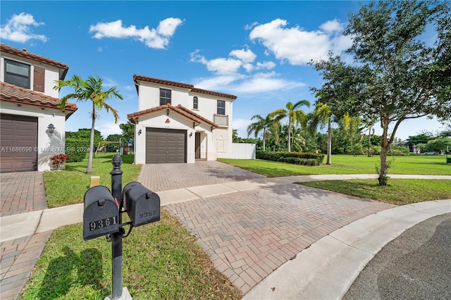 mediterranean / spanish house featuring a front yard and a garage