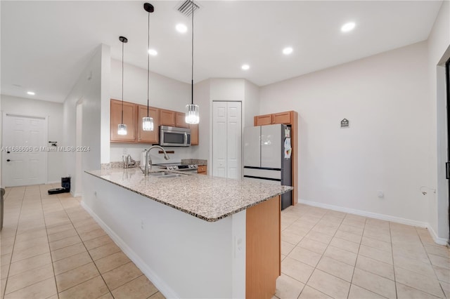 kitchen featuring kitchen peninsula, hanging light fixtures, light stone countertops, light tile patterned flooring, and stainless steel appliances