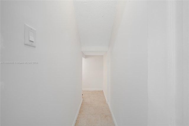 hallway featuring light tile patterned flooring