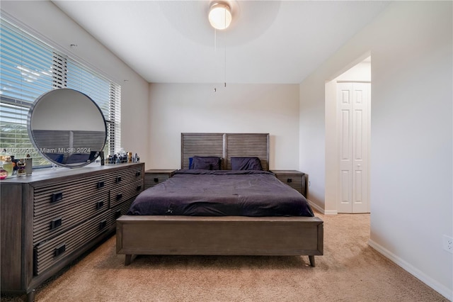 carpeted bedroom with a closet and ceiling fan