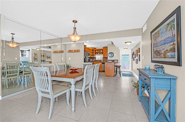 tiled dining area featuring a textured ceiling