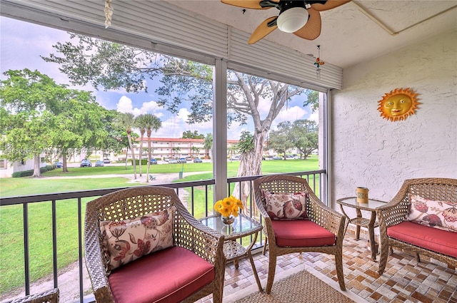 sunroom featuring ceiling fan