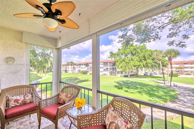 sunroom / solarium featuring ceiling fan