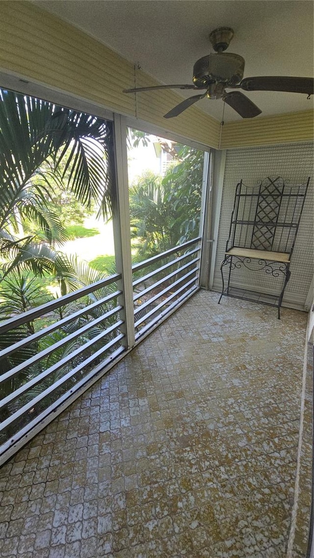 exterior space featuring ceiling fan and a balcony