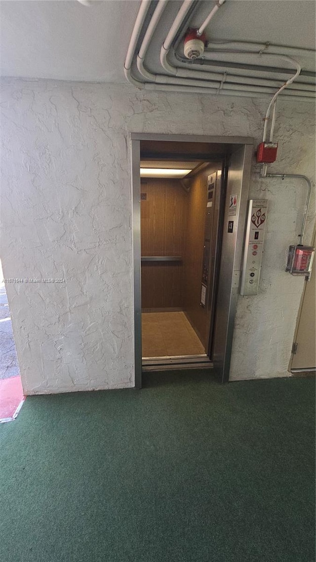 interior space featuring carpet floors and elevator