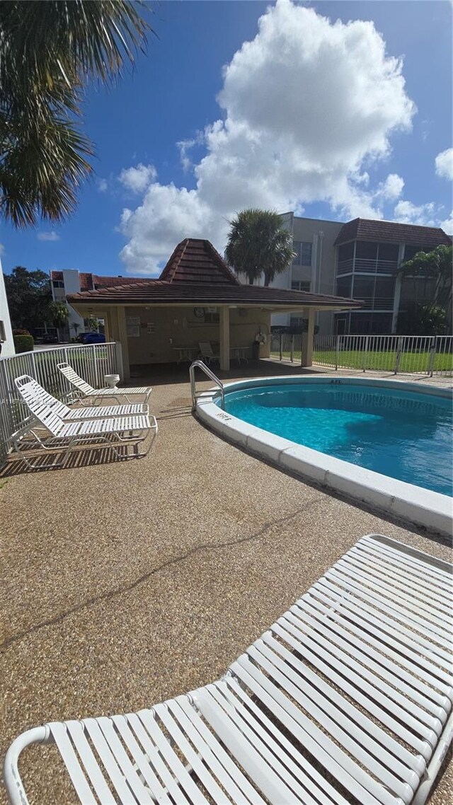 view of swimming pool with a patio