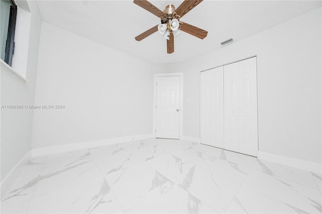 unfurnished bedroom featuring a closet and ceiling fan