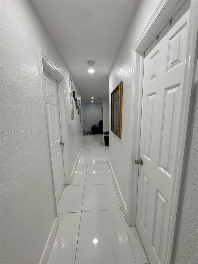 hallway featuring light tile patterned flooring