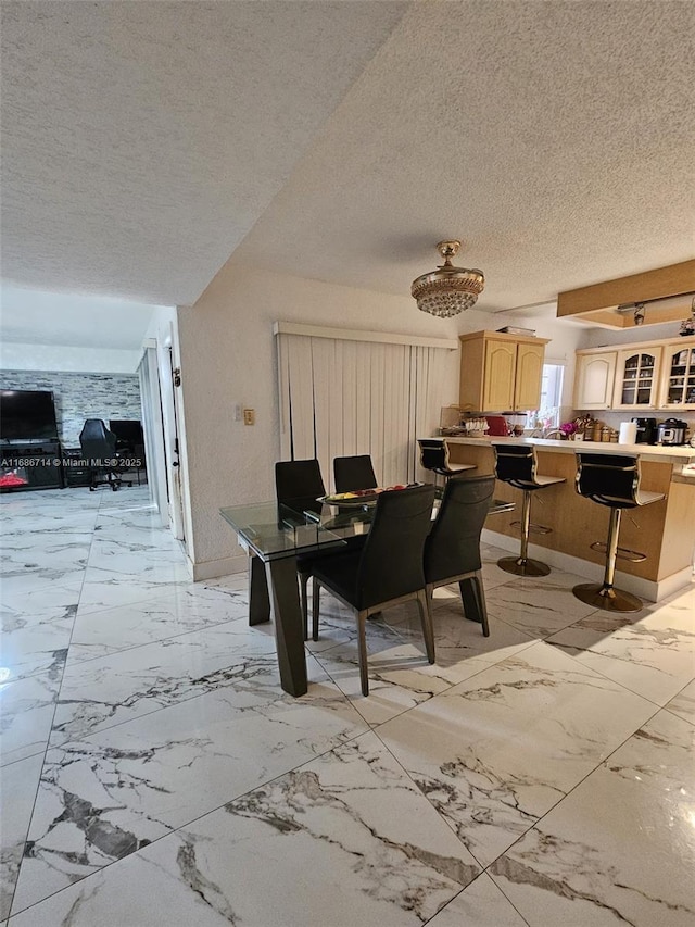 dining space with a textured ceiling