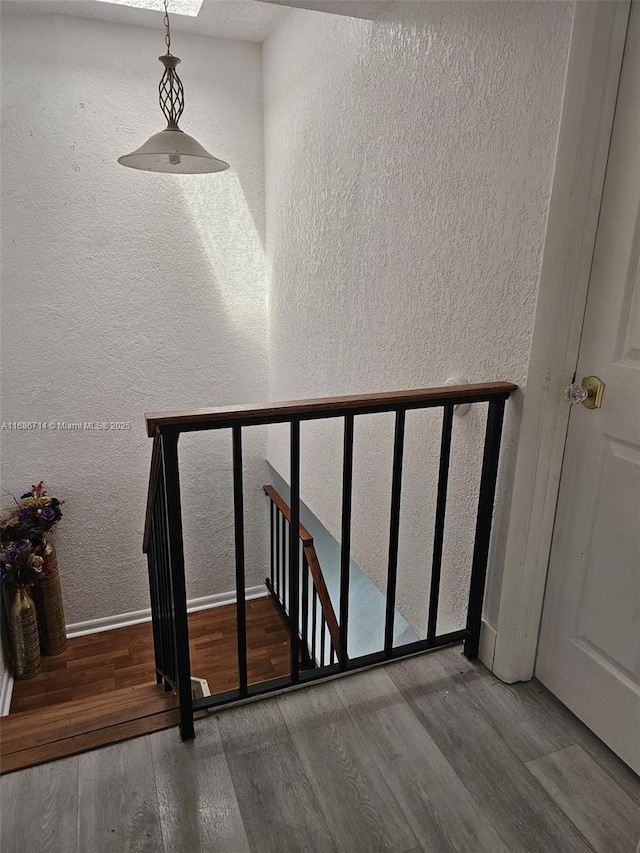 staircase with hardwood / wood-style flooring