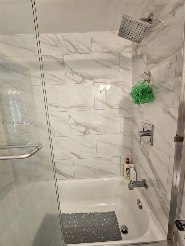 bathroom with shower / bath combination with glass door