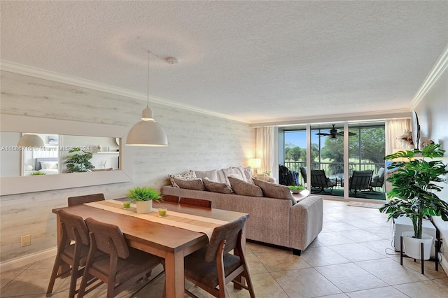 dining space with ornamental molding, a textured ceiling, and light tile patterned floors