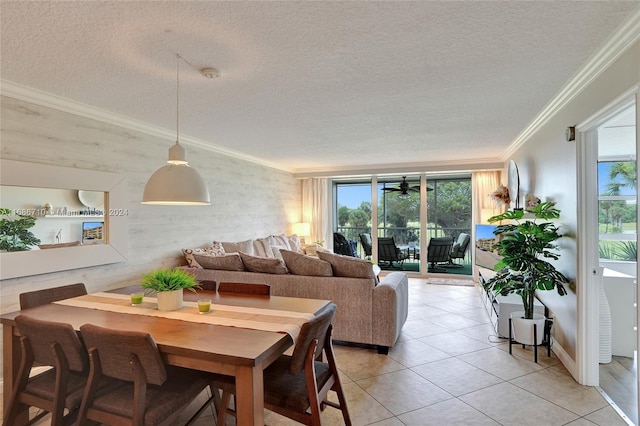 tiled dining room featuring a wealth of natural light, crown molding, and a textured ceiling