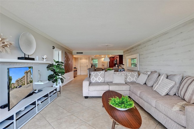 tiled living room featuring ornamental molding and a textured ceiling