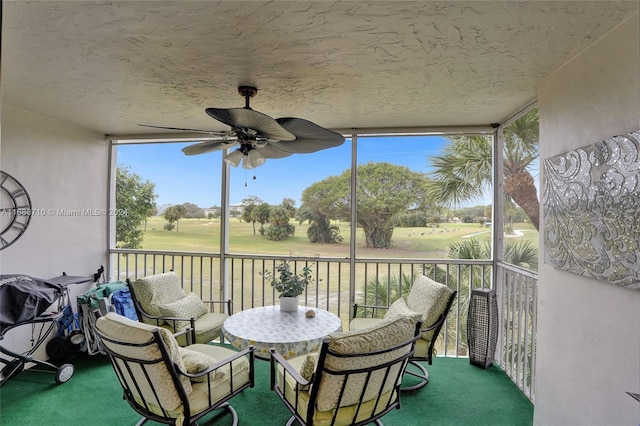 sunroom / solarium featuring ceiling fan