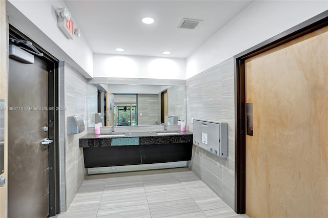 bathroom with vanity, tile walls, and tile patterned flooring