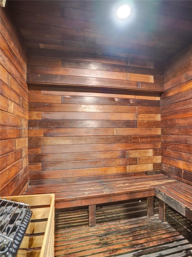 view of sauna with wood ceiling and wood walls