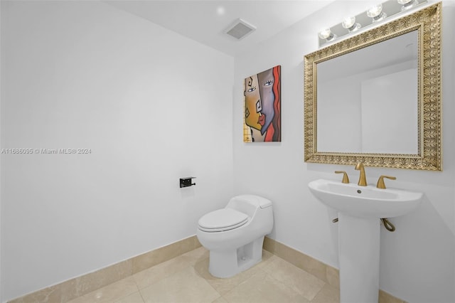 bathroom with tile patterned flooring, toilet, and sink