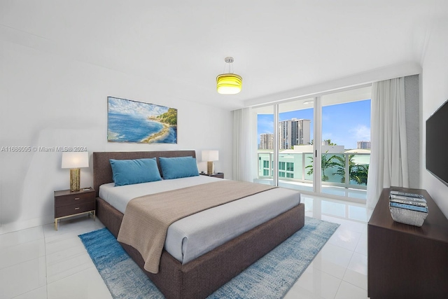 bedroom featuring expansive windows, light tile patterned flooring, and access to exterior