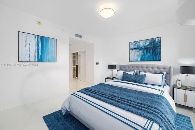 bedroom with light tile patterned floors