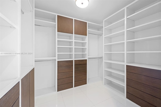 spacious closet featuring light tile patterned floors