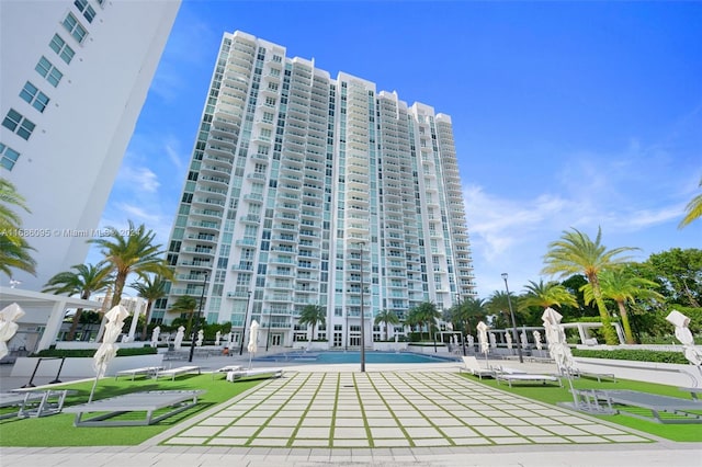 view of building exterior featuring a community pool