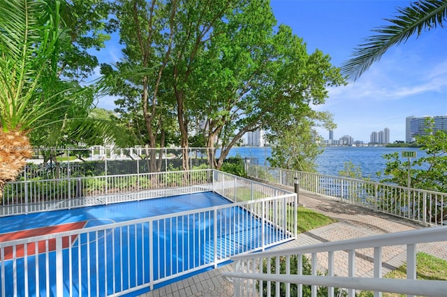 view of swimming pool with a water view