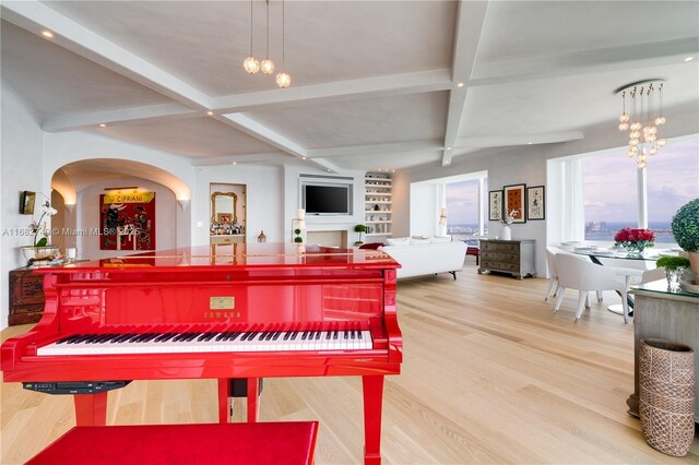 1425 Brickell Ave Unit 55F, Miami, FL 33131 - living area featuring wood finished floors, beamed ceiling, coffered ceiling, arched walkways, and a chandelier