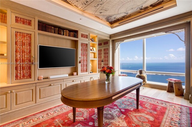 1425 Brickell Ave Unit 55F, Miami, FL 33131 - sitting room featuring wood finished floors, a tray ceiling, and built in shelves