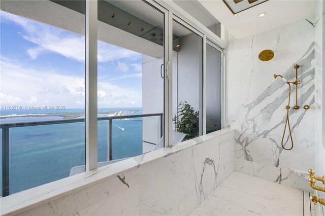 1425 Brickell Ave Unit 55F, Miami, FL 33131 - bathroom featuring a water view and a marble finish shower