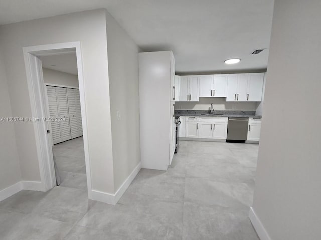 kitchen with white cabinetry, dishwasher, and sink