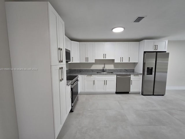 kitchen featuring white cabinetry, appliances with stainless steel finishes, and sink