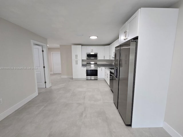 kitchen featuring stainless steel appliances and white cabinets