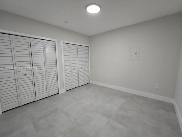 unfurnished bedroom with two closets