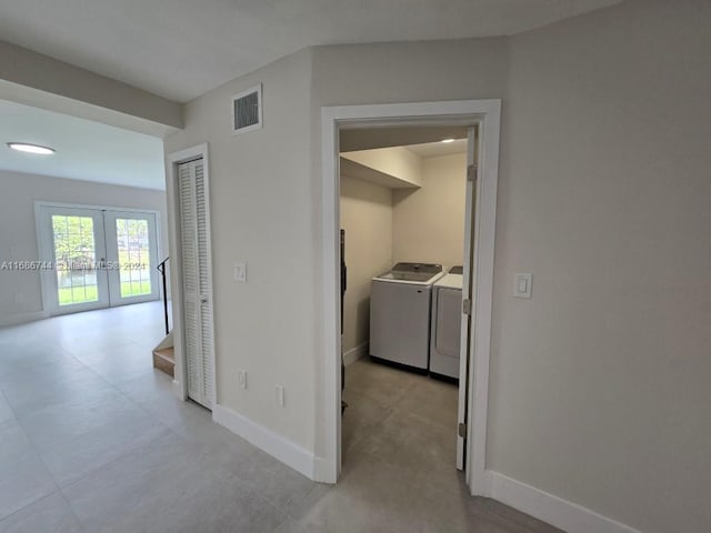 hallway featuring french doors and washing machine and clothes dryer